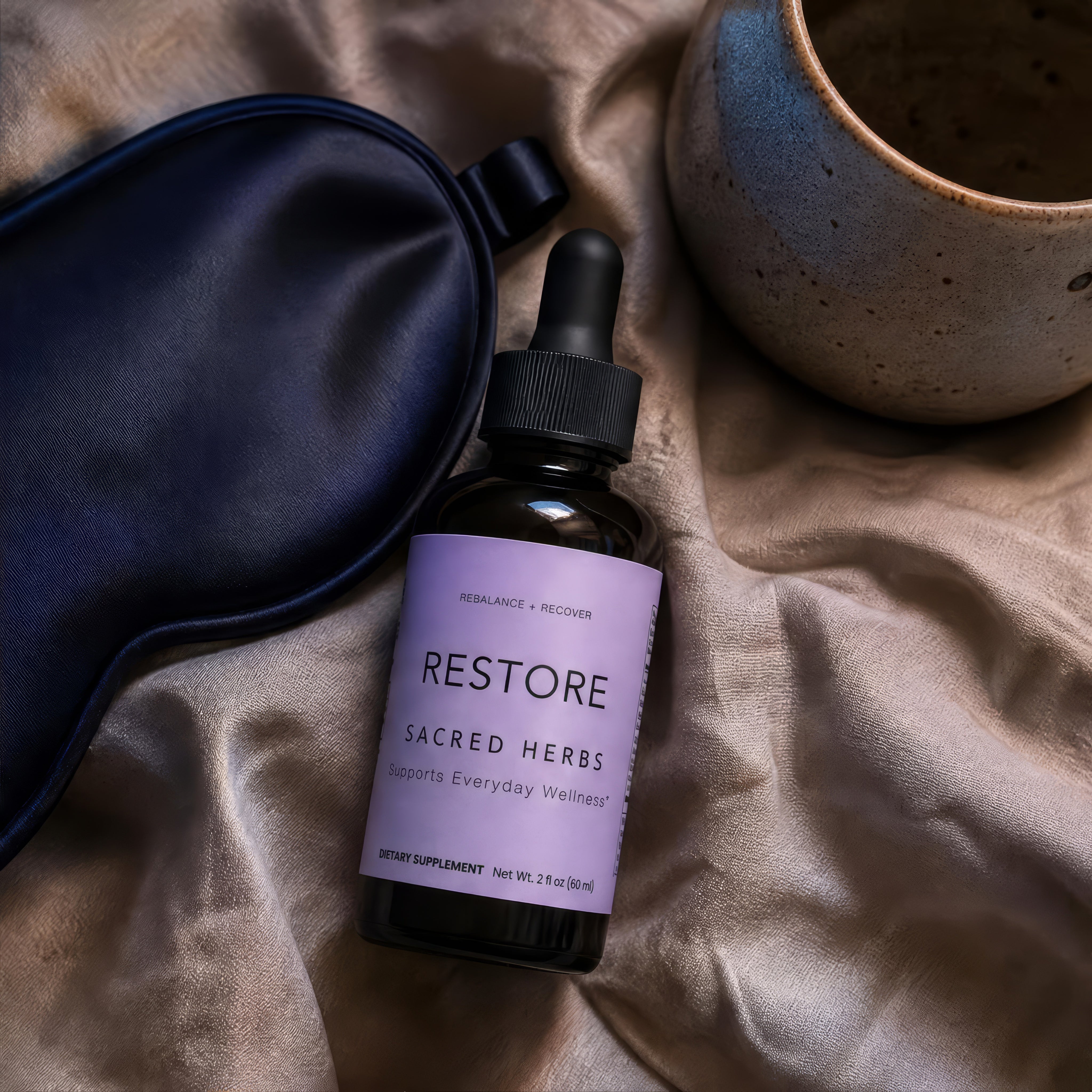 RESTORE bottle beside a cup and sleep mask