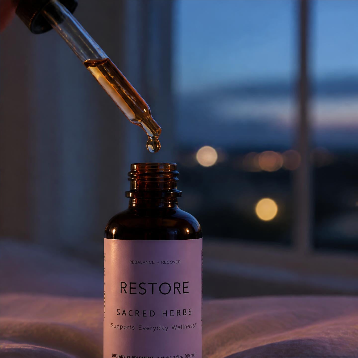 RESTORE bottle with dropper at dusk